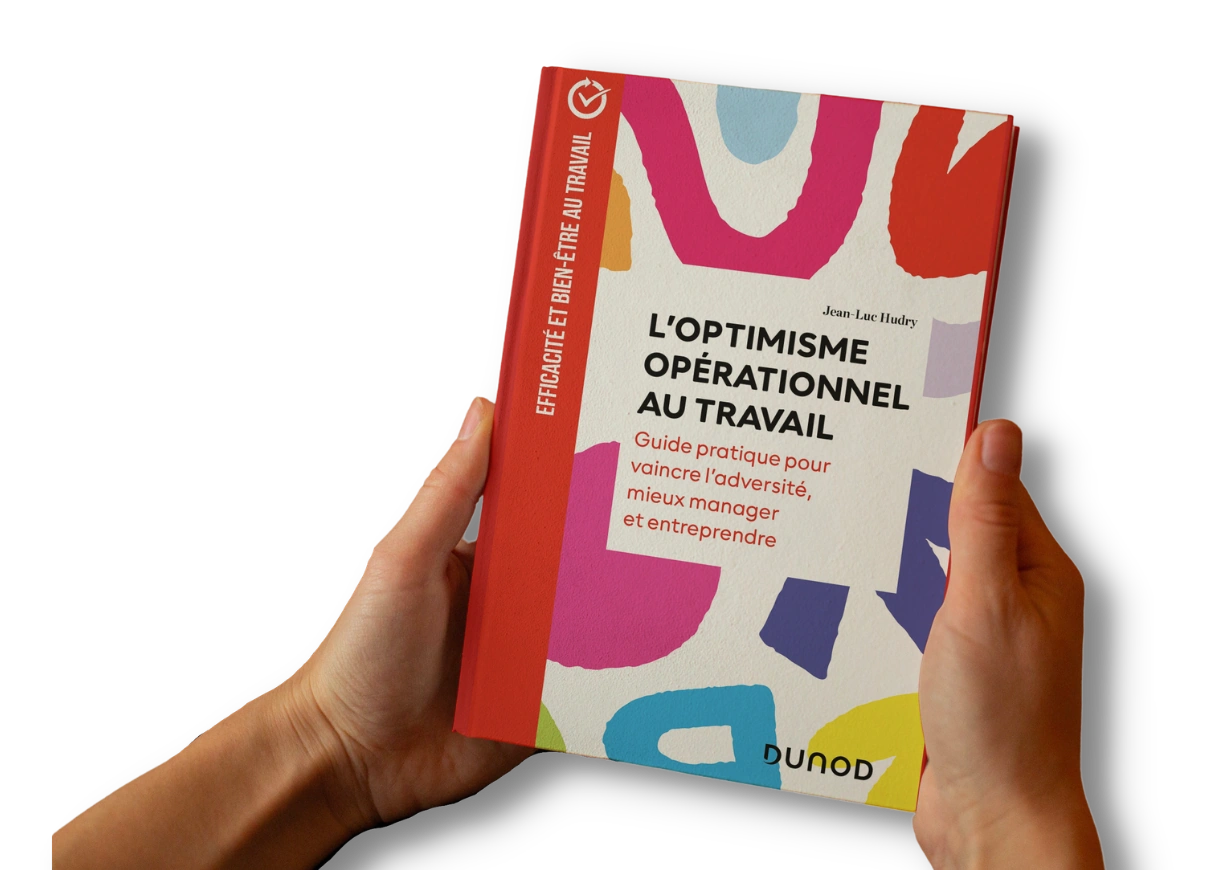 Couverture du guide L’Optimisme Opérationnel au travail de Jean-Luc Guide L’Optimisme Opérationnel au travail de Jean-Luc Hudry, publié chez Dunod, présenté entre les mains d’un lecteur.